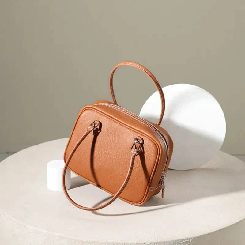 Elegant leather mini shoulder bag in a variety of colours, featuring a compact and versatile design for the stylish British woman.