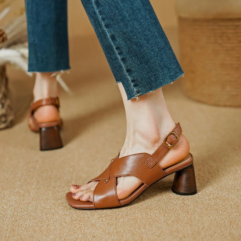 Elegant leather high heel sandals for women, featuring a refined square heel, stylish buckle strap, and sleek design for a sophisticated look.