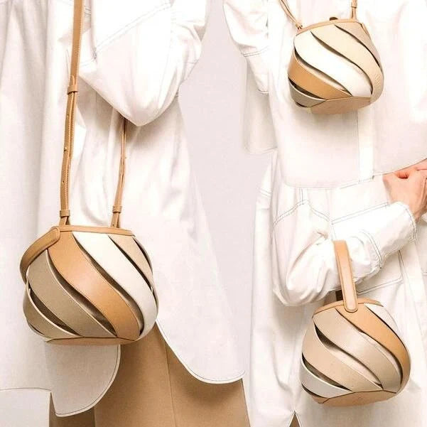 Stylish striped PU leather bucket handbag with versatile carry options and roomy interior