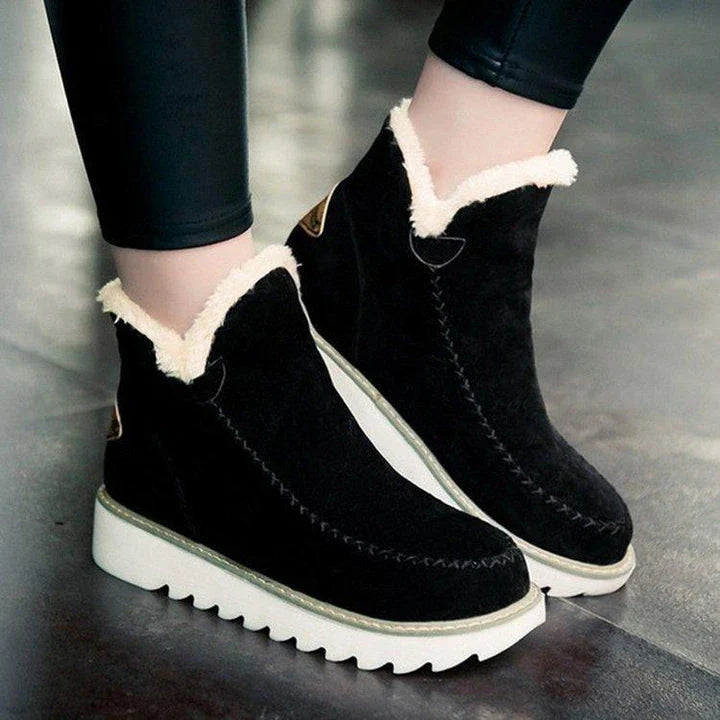 A pair of stylish, non-slip snow boots with a warm artificial wool lining, perfect for British winter weather