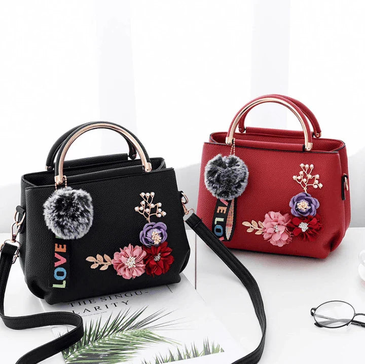 Elegant leather tote bag with delicate flower embellishments, perfect for modern British fashion