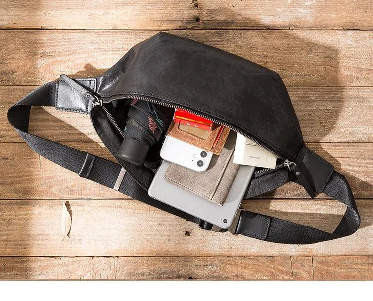 Premium cowhide messenger bag in black, featuring a spacious interior, adjustable shoulder strap, and sleek, minimalist design