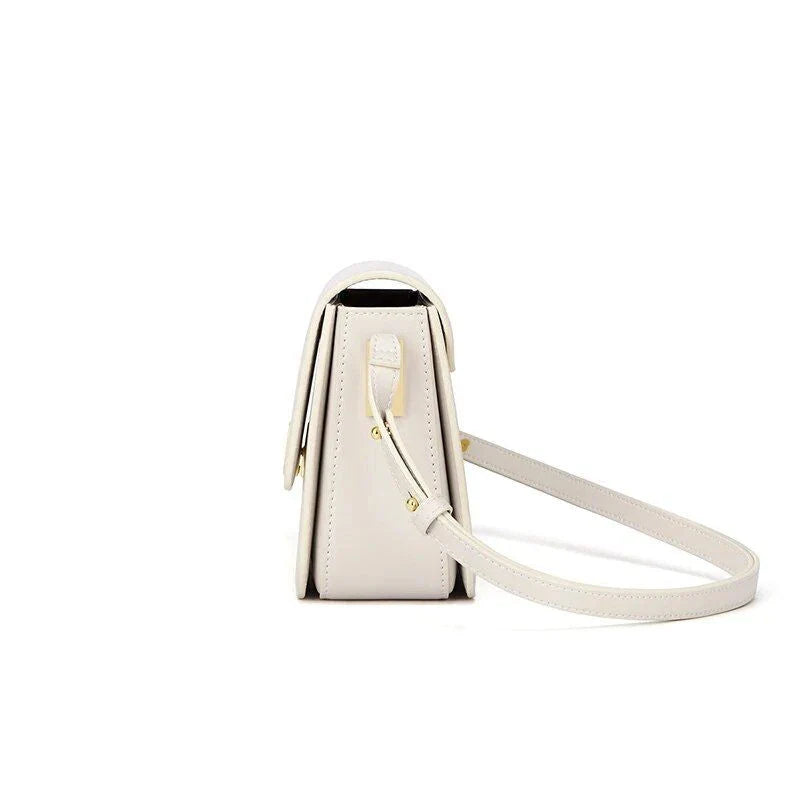 Stylish British-inspired leather shoulder and crossbody bag in black, tan, and navy colours