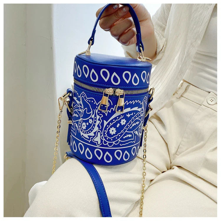 Premium PU leather bucket bag in a variety of classic and contemporary colours, featuring a spacious main compartment, adjustable shoulder strap, and sophisticated British-inspired design.