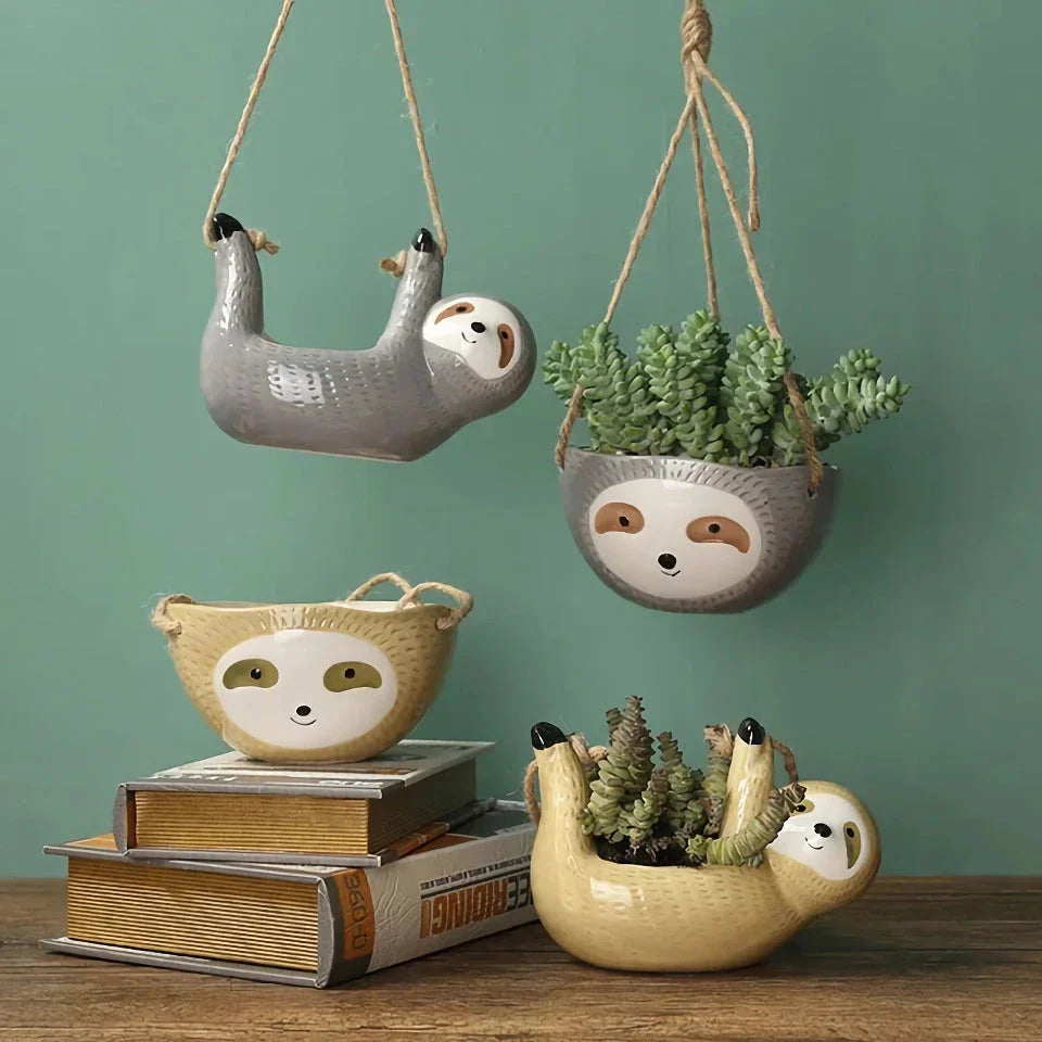 Ceramic hanging planter with a whimsical cartoon animal design, available in grey or yellow, for adding a touch of nature and playfulness to indoor spaces.