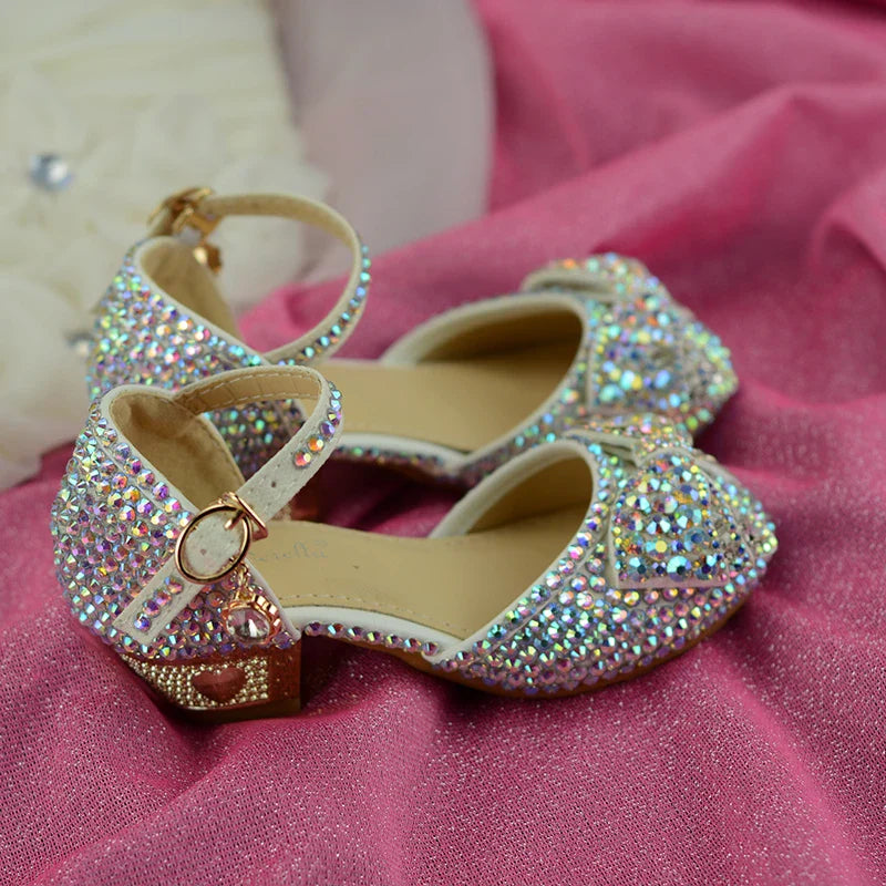 Enchanting princess crystal shoes with bow detail and dazzling crystals, perfect for girls' special occasions