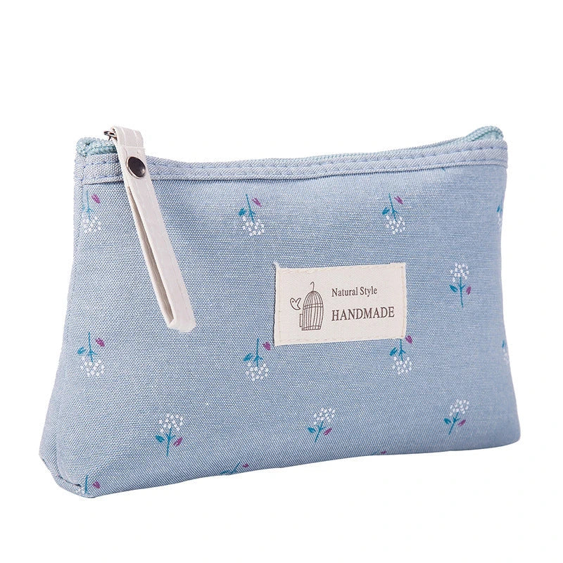 A stylish floral canvas cosmetic bag with a secure zipper closure, perfect for organising and carrying your makeup and toiletries while traveling.