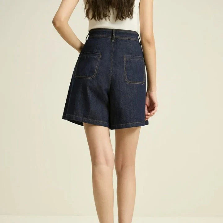 Dark denim high-waist loose shorts with retro pleated design, offering comfort and style for the modern British woman.