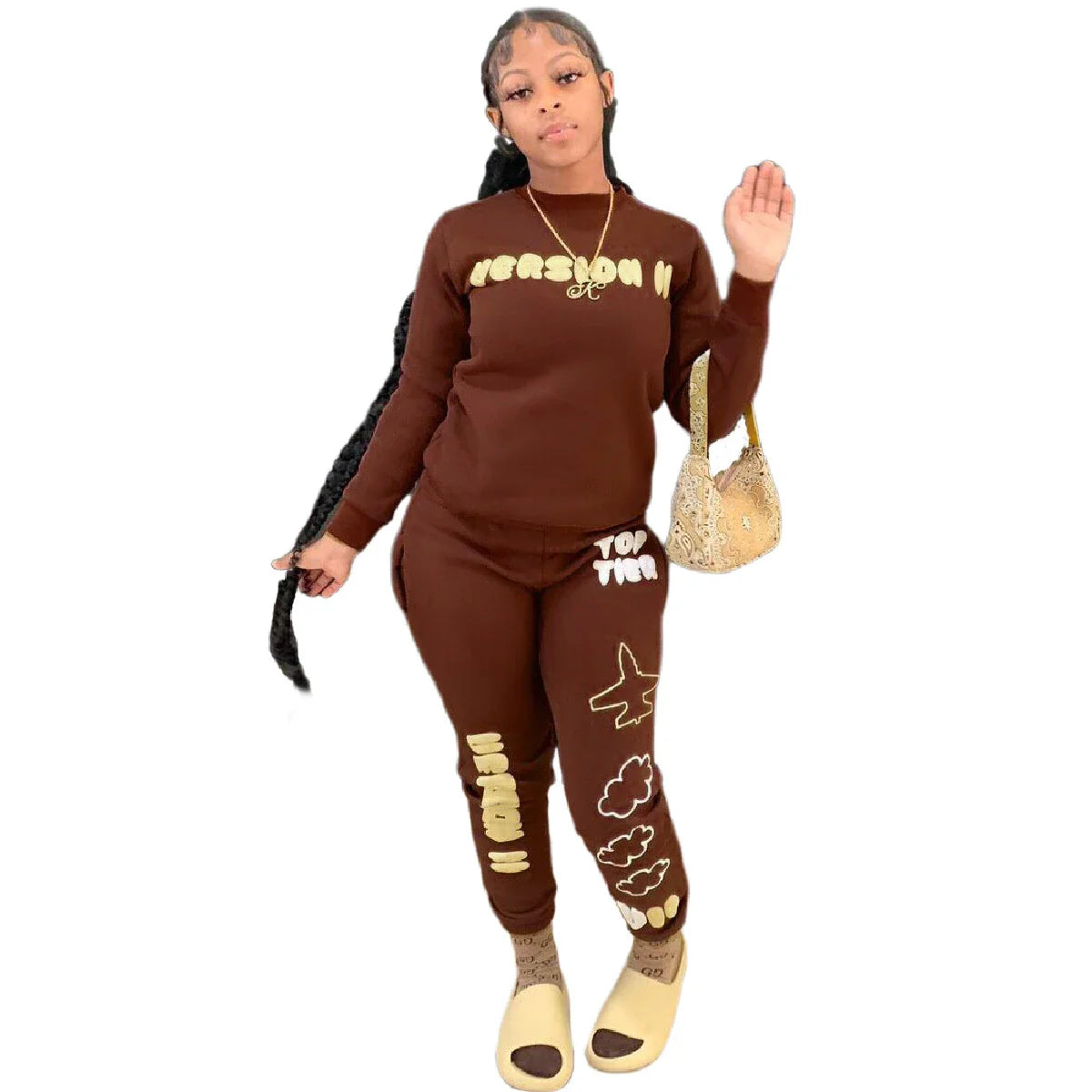 Stylish two-piece casual sports outfit for women, featuring a relaxed top and comfortable trousers in black and brown colors.