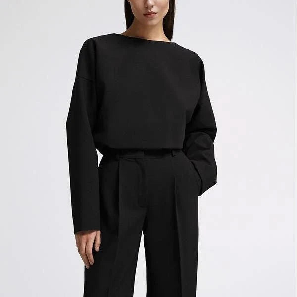 Elegant and sophisticated women's two-piece office suit with long sleeve top and wide-leg pants in a neutral colour palette