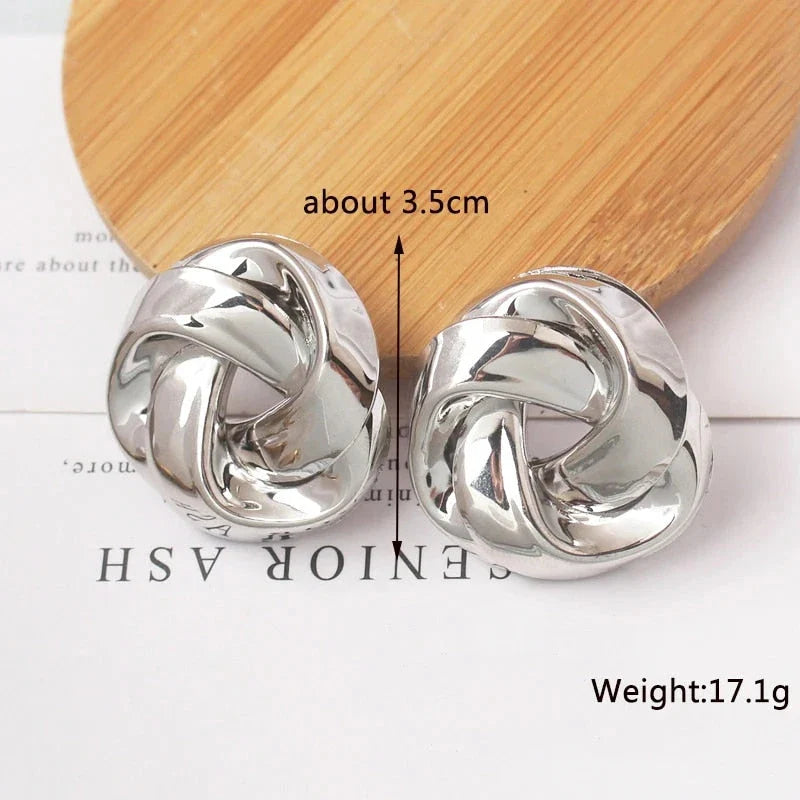 Pair of gold spiral drop earrings with an exaggerated, dramatic design for a bold, fashionable look