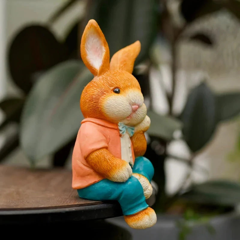 A detailed and lifelike resin statue of a thoughtfully sitting rabbit, adding a whimsical touch to any home or garden decor.
