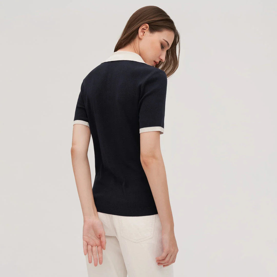 Stylish silk knit polo shirt in navy blue, featuring a slim fit design, contrasting trim, and a feminine v-neckline for refined British elegance.