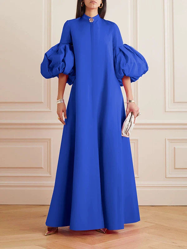 Elegant floral evening gown in a range of vibrant colours, featuring a loose, flattering fit and chic lapel design