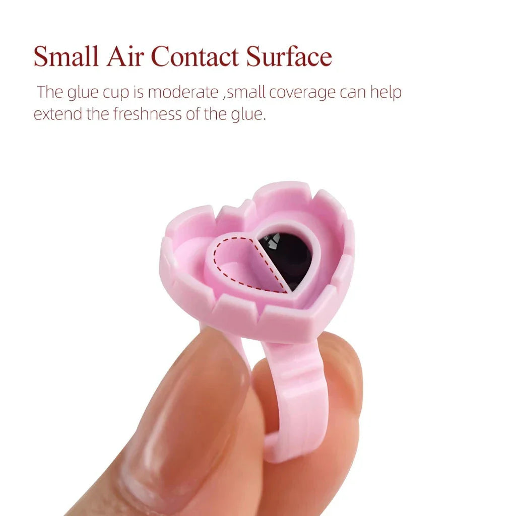 Heart-shaped disposable eyelash glue rings in blue, pink, and white colours
