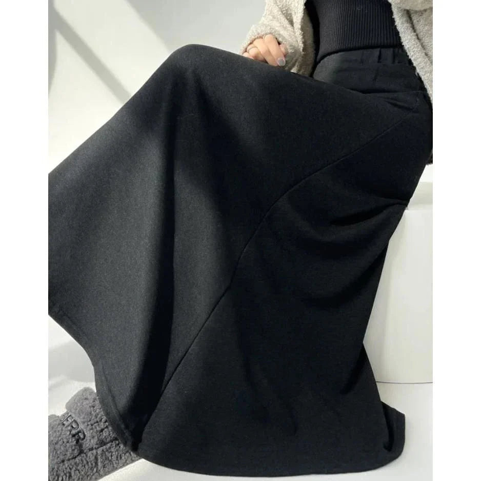 Elegant high-waist knitted skirt in black, showcasing a flattering A-line silhouette and ankle-length cut for the modern British woman.
