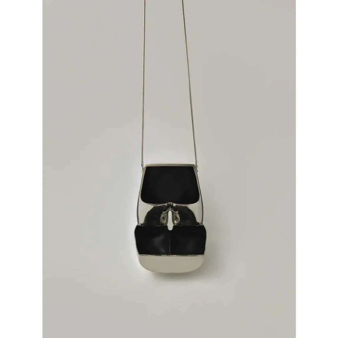 Elegant silver acrylic evening clutch bag with stylish chain strap for versatile carrying