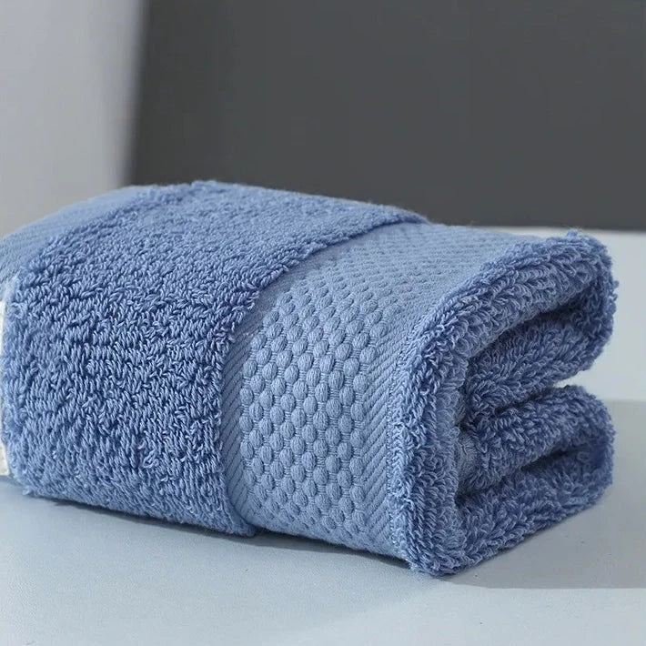 Premium 100% cotton face towel in blue, featuring a soft and absorbent design for daily facial cleansing and bathing