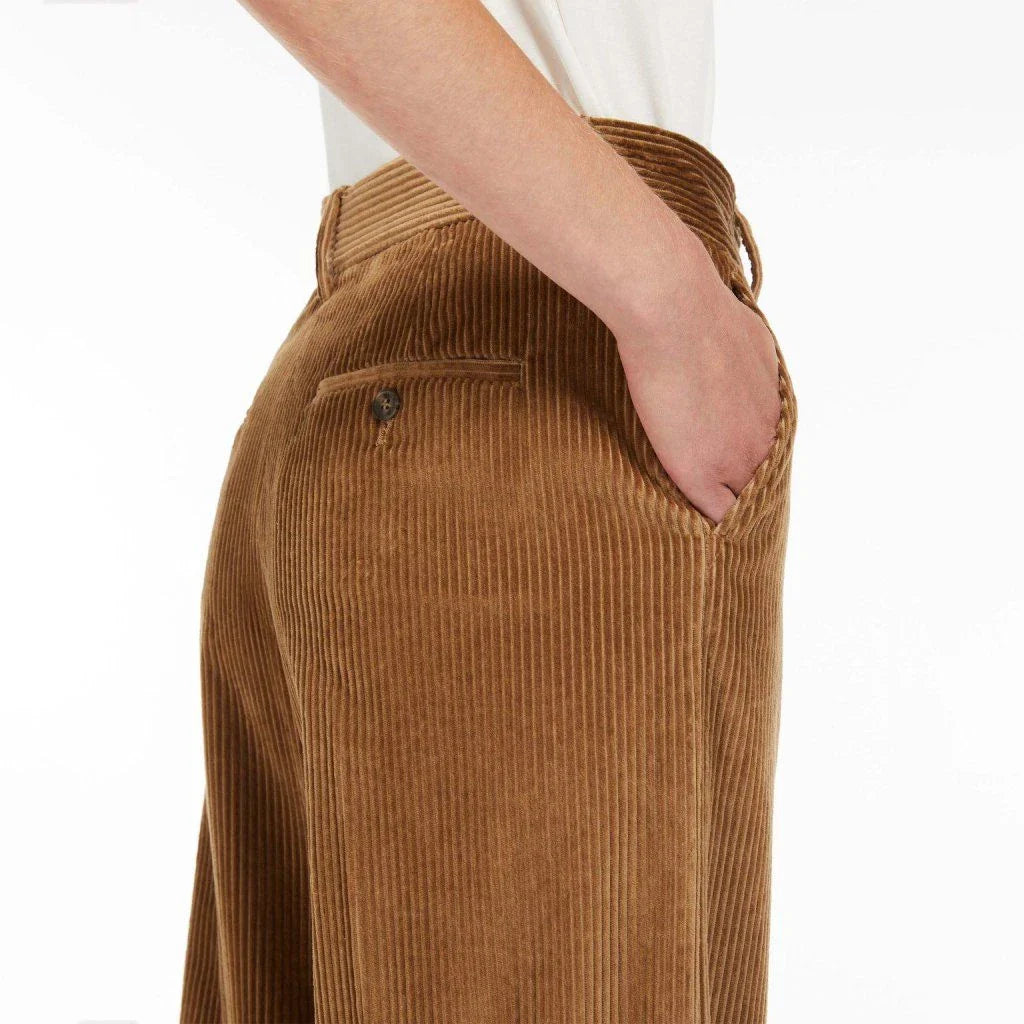 A pair of high-waist, wide-leg corduroy trousers in a classic red colour, designed for the modern British woman's wardrobe.