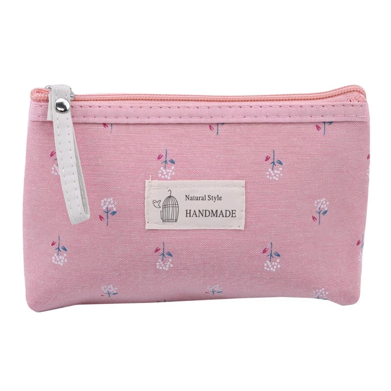 A stylish floral canvas cosmetic bag with a secure zipper closure, perfect for organising and carrying your makeup and toiletries while traveling.