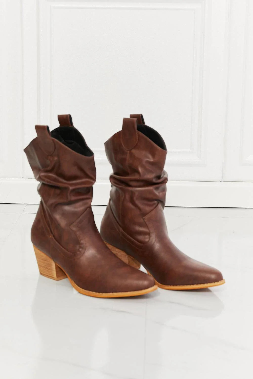 Stylish scrunch cowboy boots in a rich brown colour, perfect for pairing with jeans or dresses for a touch of rustic charm.