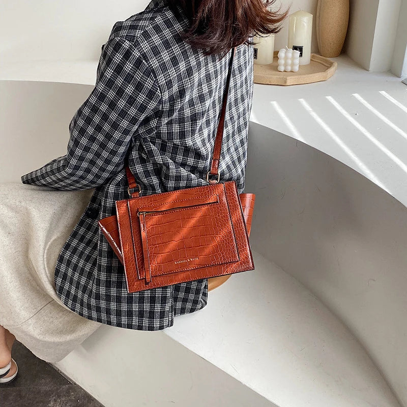 Premium British-designed messenger bag in wine red colour, featuring a spacious and stylish design with a single strap for comfortable carrying.