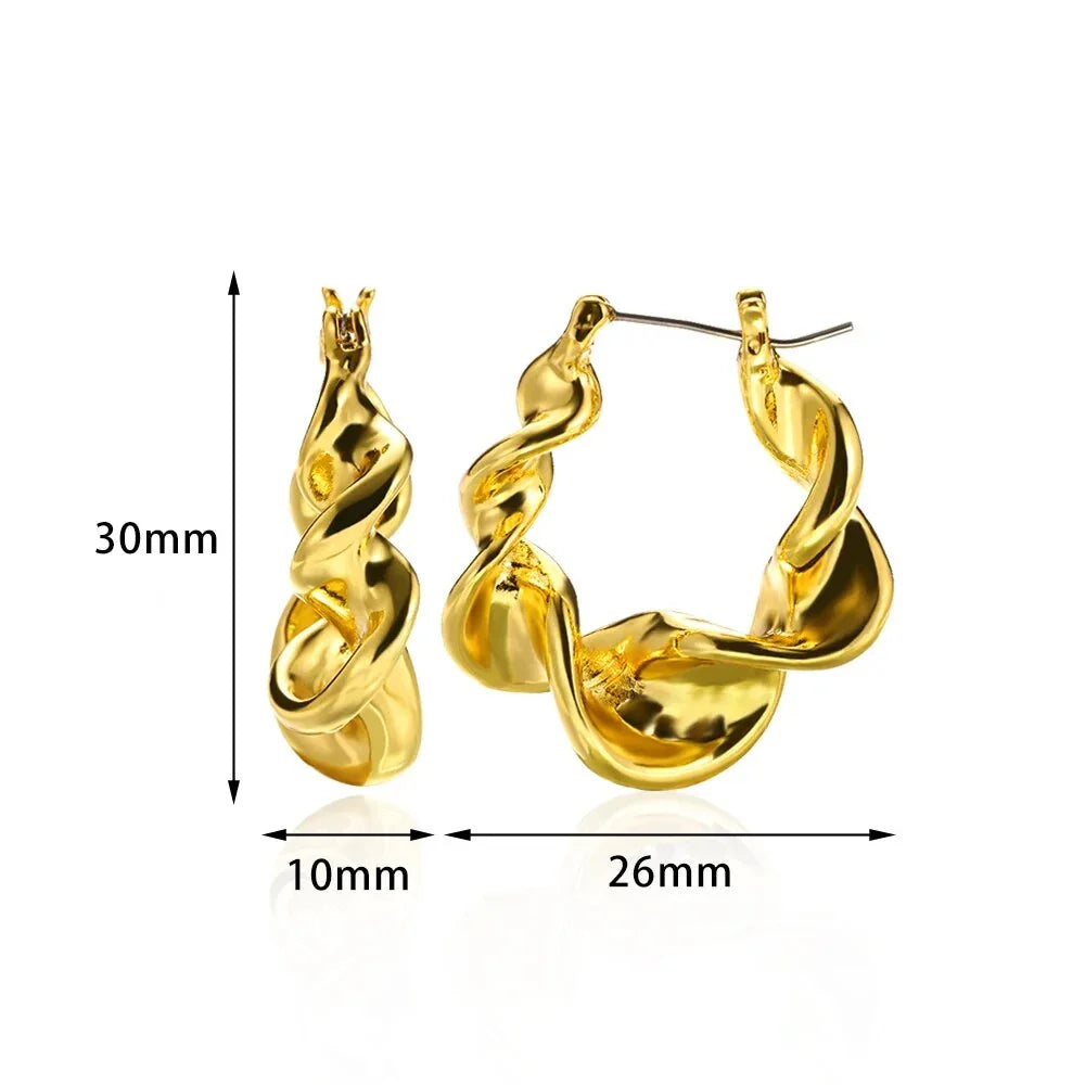 A pair of gold-toned stainless steel hoop earrings, showcasing a classic and sophisticated design