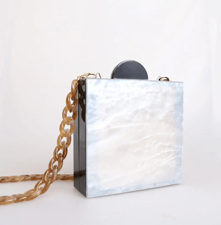 Antique hand-stitched acrylic crossbody bag in a vintage style with a yellow chain strap, perfect for evening events or everyday use.
