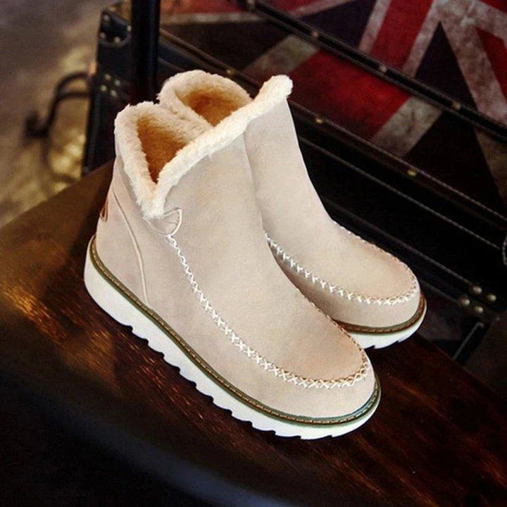 A pair of stylish, non-slip snow boots with a warm artificial wool lining, perfect for British winter weather