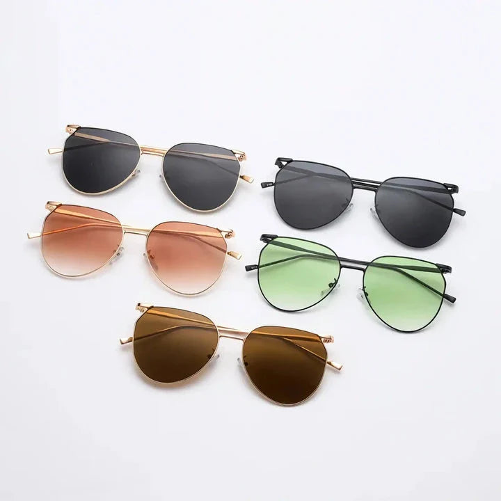 Elegant oval-shaped sunglasses with gradient lenses and alloy frames, offering timeless British style and UV protection.