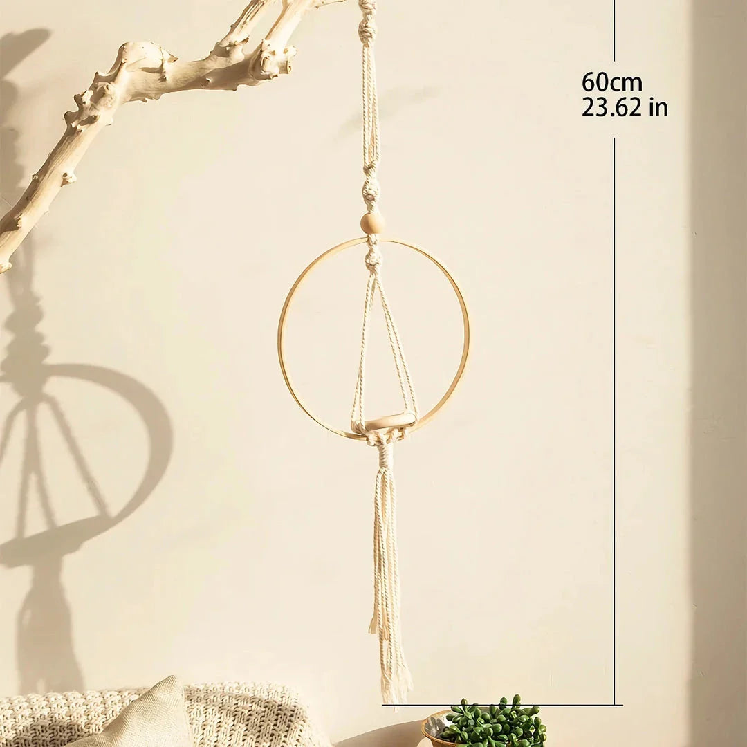 A macrame air plant hanging holder with a chic, boho-inspired design, perfect for adding organic texture and soothing vibes to any room.