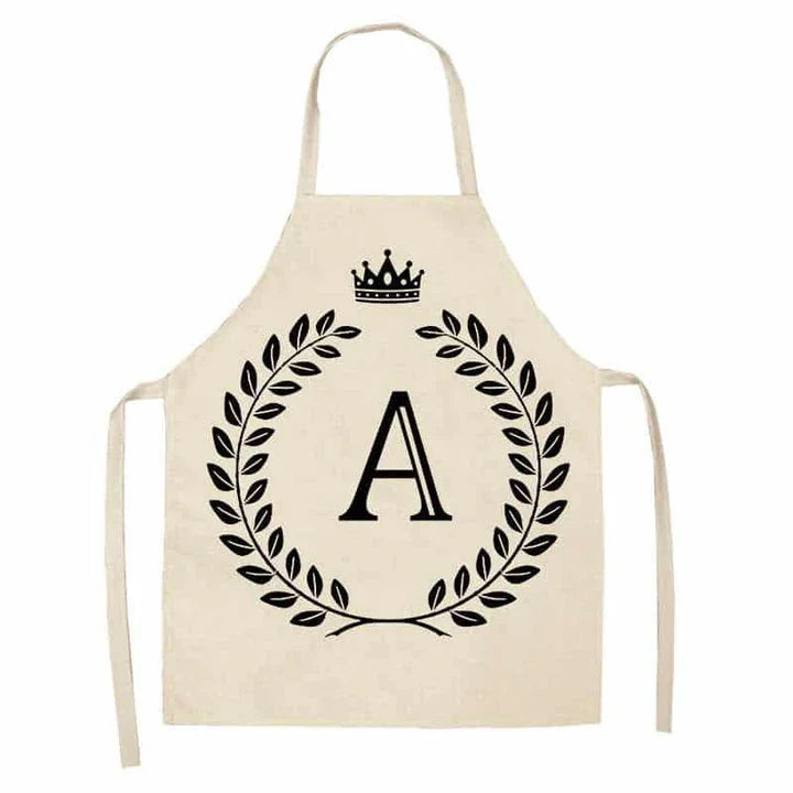 A high-quality kitchen apron featuring a charming crown and letter print design in a premium cotton and linen blend fabric.