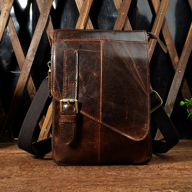 Premium cowhide leather one-shoulder crossbody bag in light grey colour with adjustable strap and zipper pocket