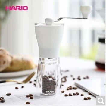 Stylish powder coffee grinder in black and red, with a manual grinding mechanism for consistent and freshly ground coffee.