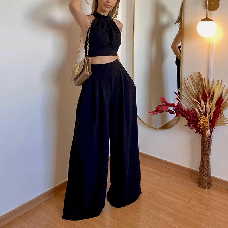 A stylish two-piece set with a halter-neck top and relaxed, high-waisted trousers in a range of sophisticated colours