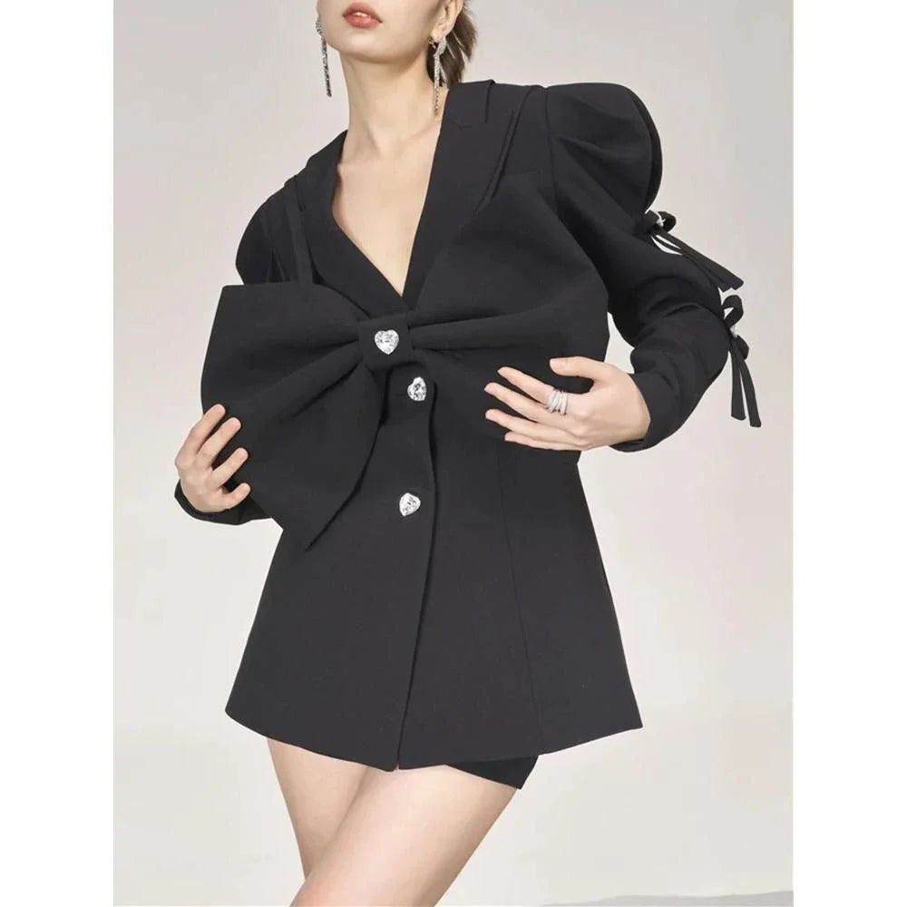 Stylish women's white blazer with a sparkling diamond bow accent, designed for fashion-forward British women