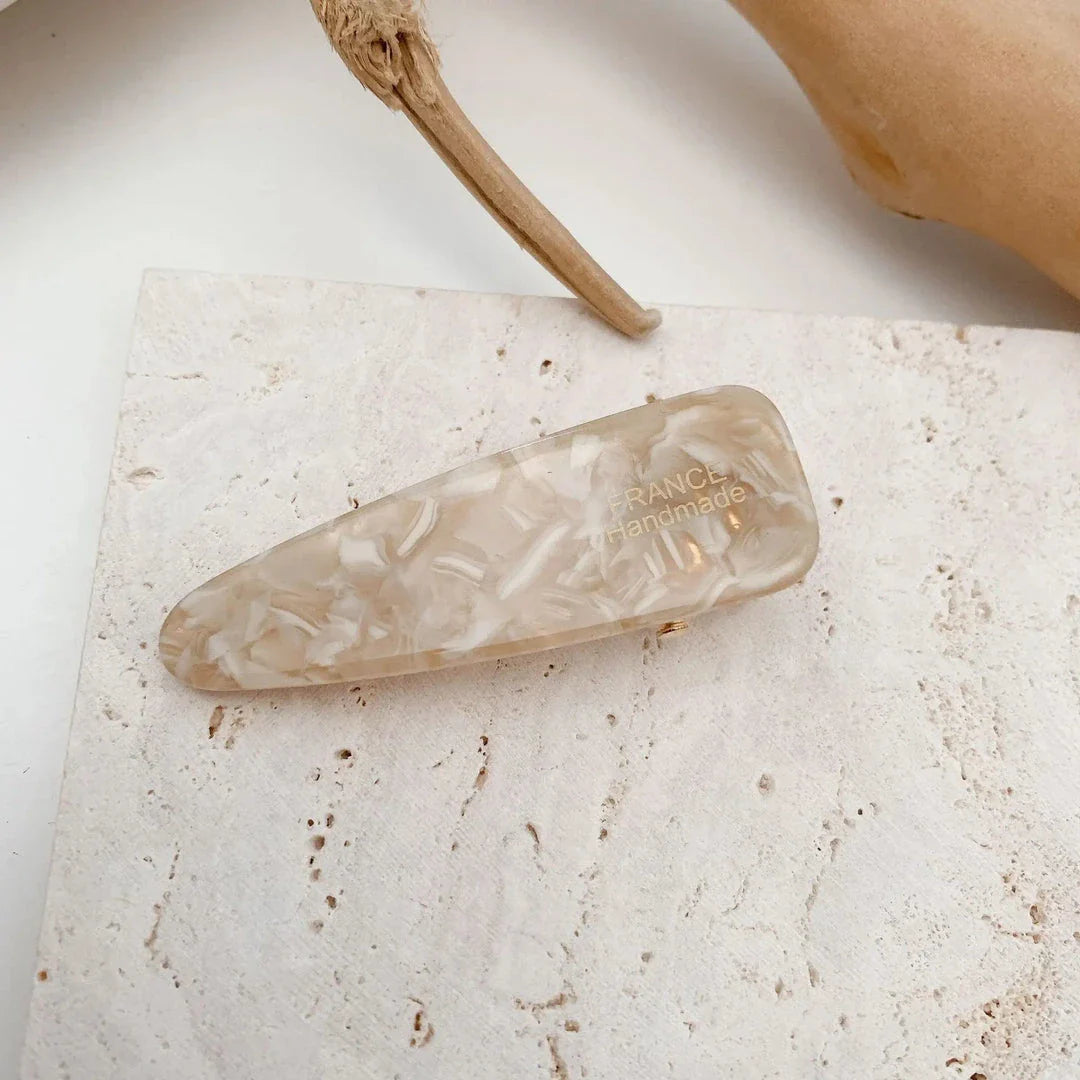 Two marble-patterned hair clips in a contemporary geometric design, made from high-quality acetate and acrylic materials.
