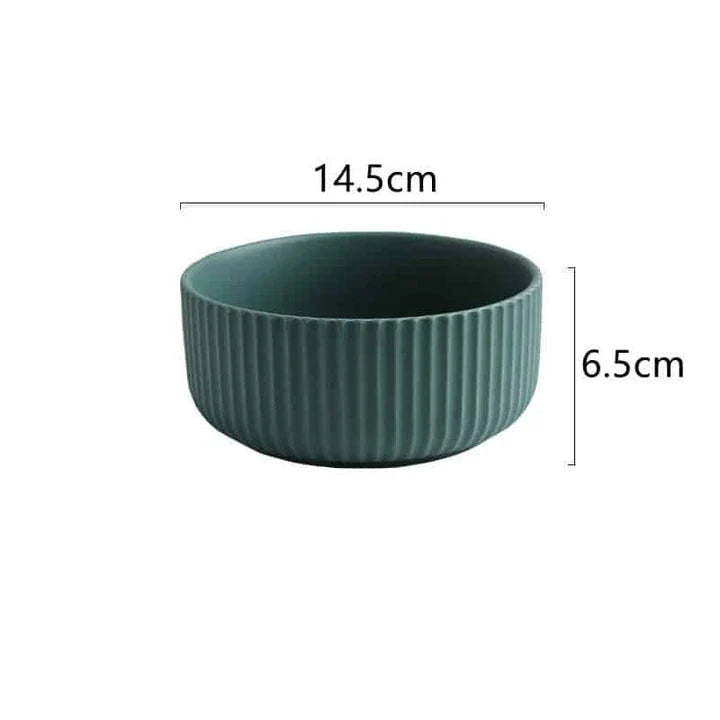 Candy-coloured ribbed ceramic tableware featuring plates, bowls, and other dining accessories in vibrant hues