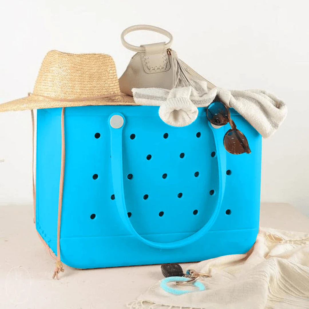 Premium waterproof beach tote bag in various vibrant colours, featuring spacious main compartment and multiple pockets for organised storage