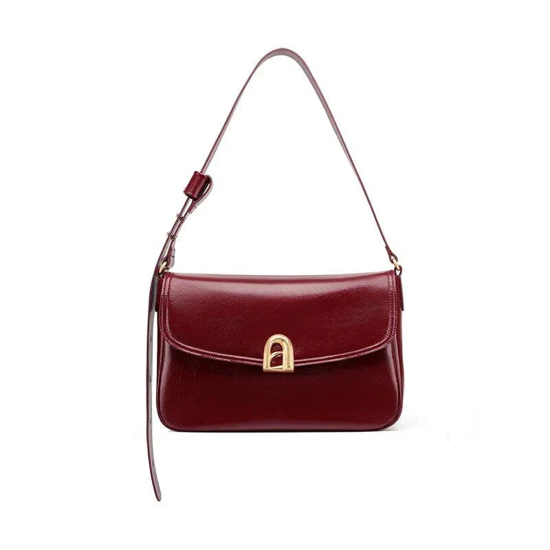 Stylish leather shoulder and crossbody bag in burgundy colour, with a square silhouette and sleek design