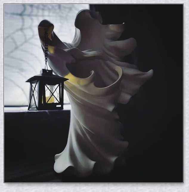 Chillingly elegant Halloween witch/ghost resin statue with eerie illumination, a unique blend of spooky charm and refined artistry for unforgettable seasonal decor