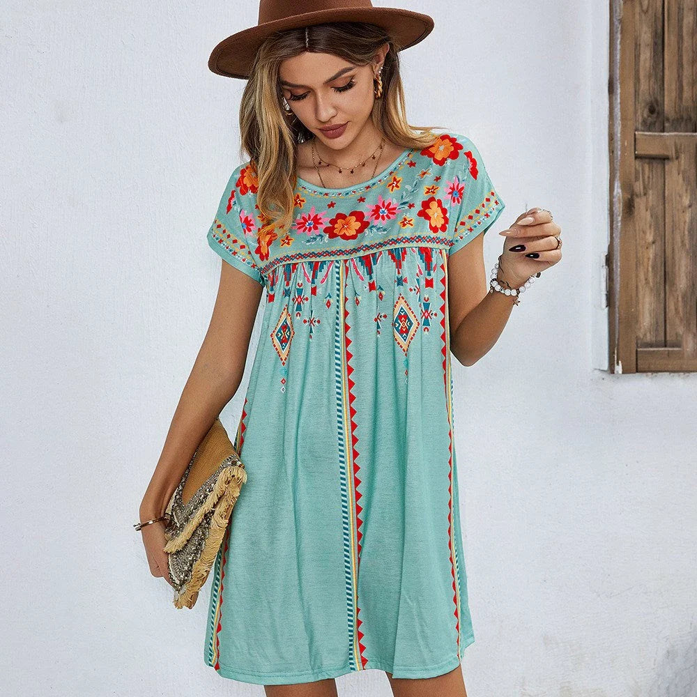 A stylish bohemian-inspired short dress with a geometric pattern, A-line silhouette, and short sleeves, suitable for warm weather