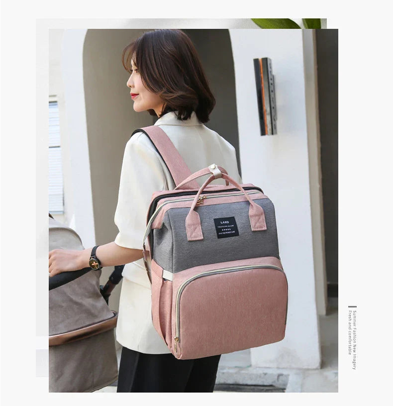Multifunctional maternity diaper backpack with removable mosquito net, foldable crib, and water-resistant design for convenient family travel