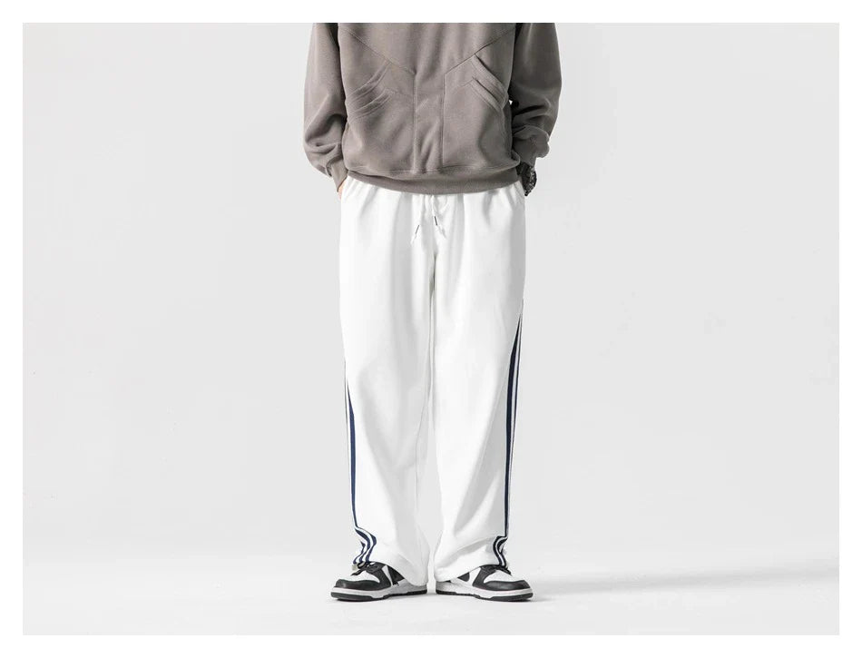 Stylish striped sports trousers in a relaxed, mid-waist design for versatile leisure and athletic wear
