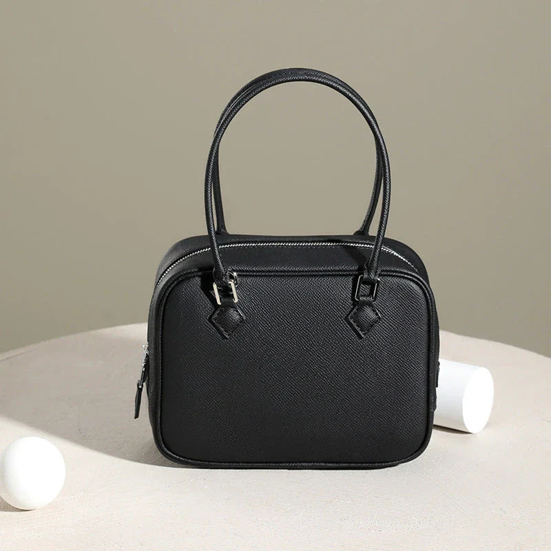 Elegant leather mini shoulder bag in a variety of colours, featuring a compact and versatile design for the stylish British woman.