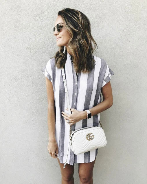 Casual striped short sleeve shirt dress in pink and blue colours, featuring a relaxed, flowing silhouette and button-down closure