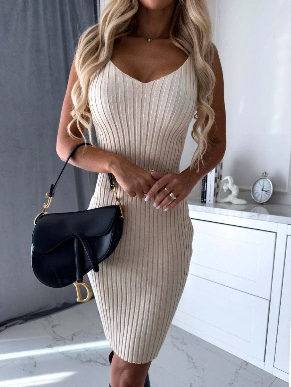 A 2-piece outfit featuring a long-sleeved striped top and a mid-length suspender skirt, perfect for autumn and winter fashion.