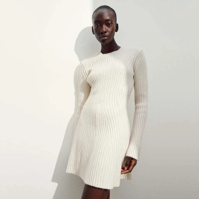 Elegant knitted mini dress with O-neck design, featuring long sleeves and a flattering sheath silhouette