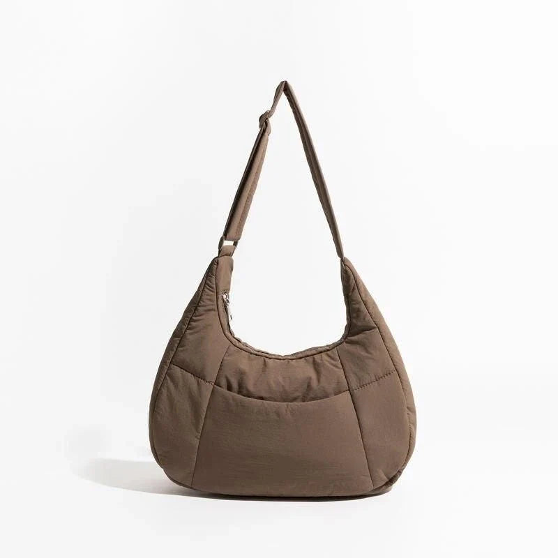 Chic Half Moon Puffer Shoulder Bag in a stylish pink colour, featuring a unique design and practical features for the modern woman.