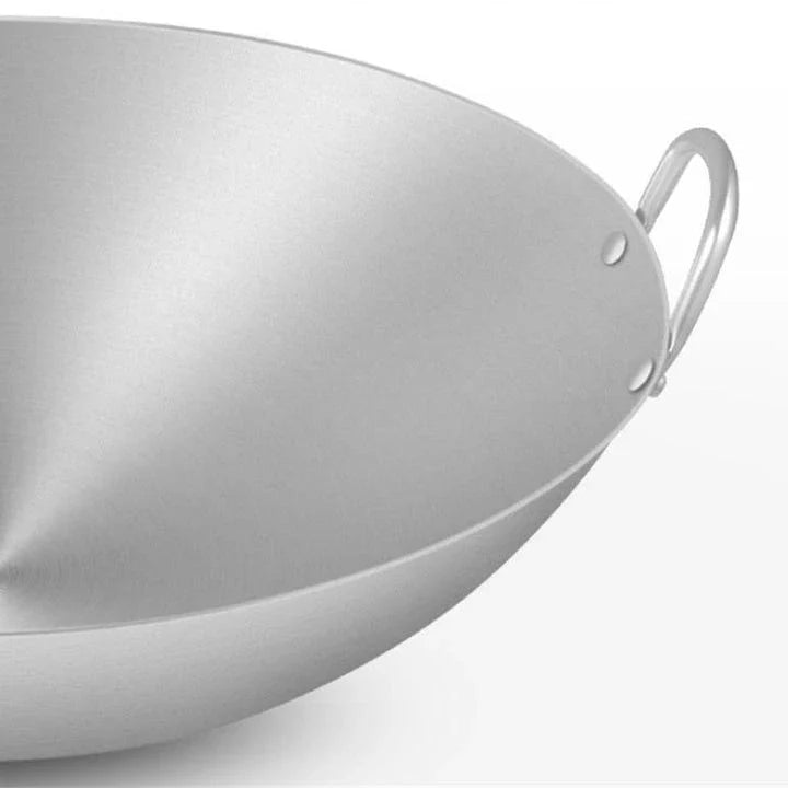 Premium British-made cast iron wok pan with superior heat retention and even heat distribution for versatile cooking